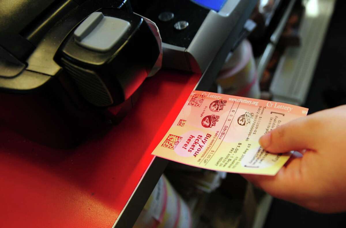 A Sales Associate scans a CT Lottery ticket at the Food Bag Citgo gas station in Shelton, Conn.