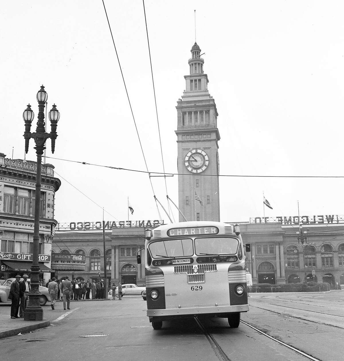 June 4, 1949: The first Municipal Railway electric bus is hooked up on Market Street near the Ferry Building.