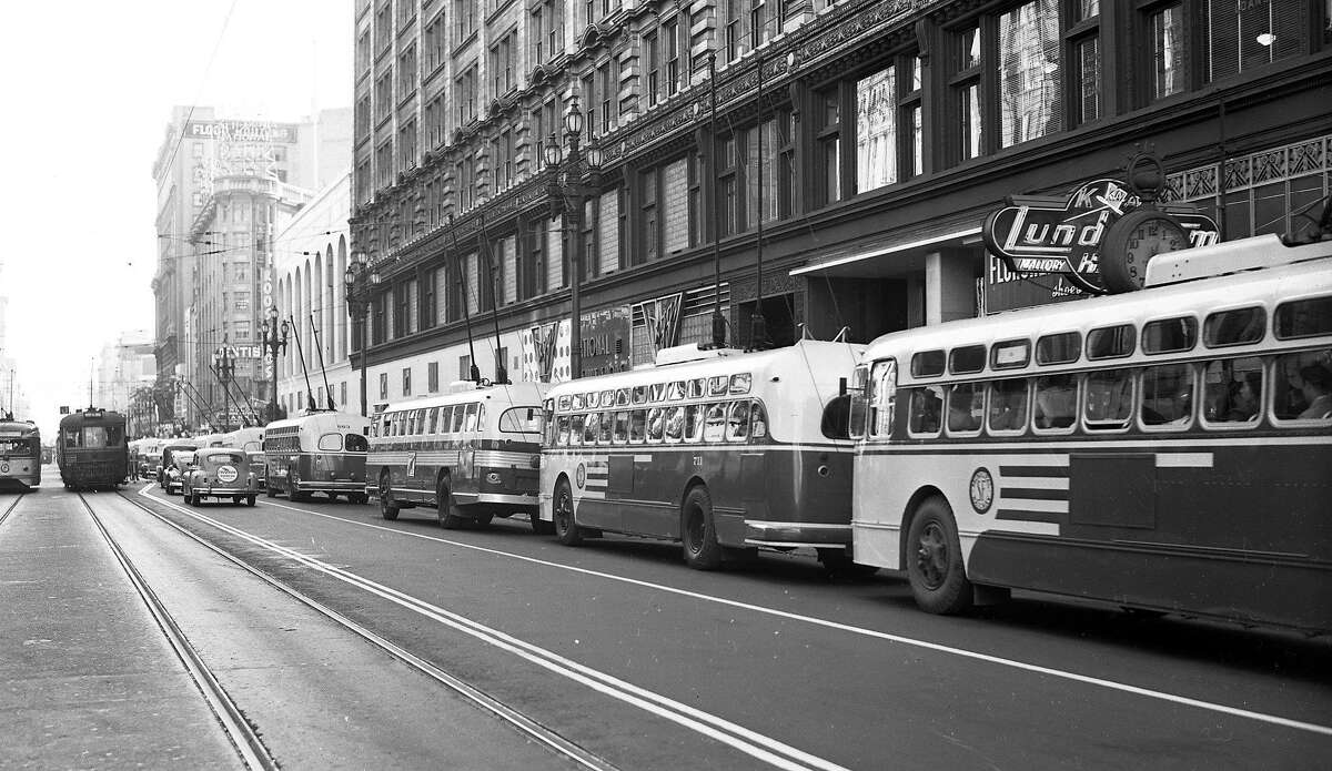 A row of new Municipal Railway electric "trackless trolley" buses wait for service on Market Street in San Francisco on July 5, 1949.