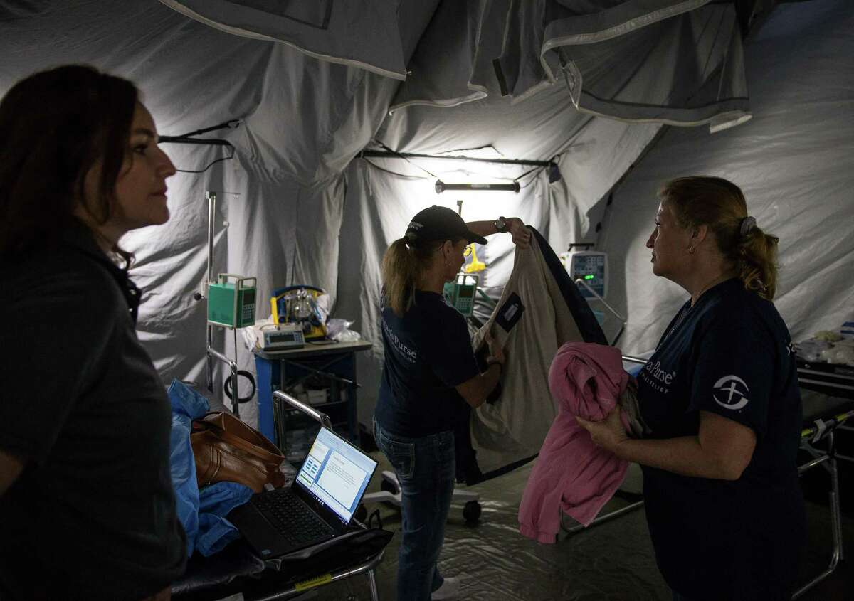 (From left) Kelly Sites, Regina Randolph and Claudia Evick of Samaritan's Purse work to assemble an emergency field hospital before a media tour at Lakewood Church in Houston, Texas on Thursday, Feb. 22, 2018. Samaritan's Purse deployed a similar emergency field hospital in Iraq in early 2017. ( Loren Elliott/ For the Houston Chronicle )