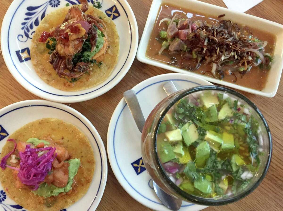 Clockwise from bottom right: Seafood cocktail, salmon carnitas taco, soft shell crab taco and Peruvian Ceviche Nikkei from Villa Rica.
