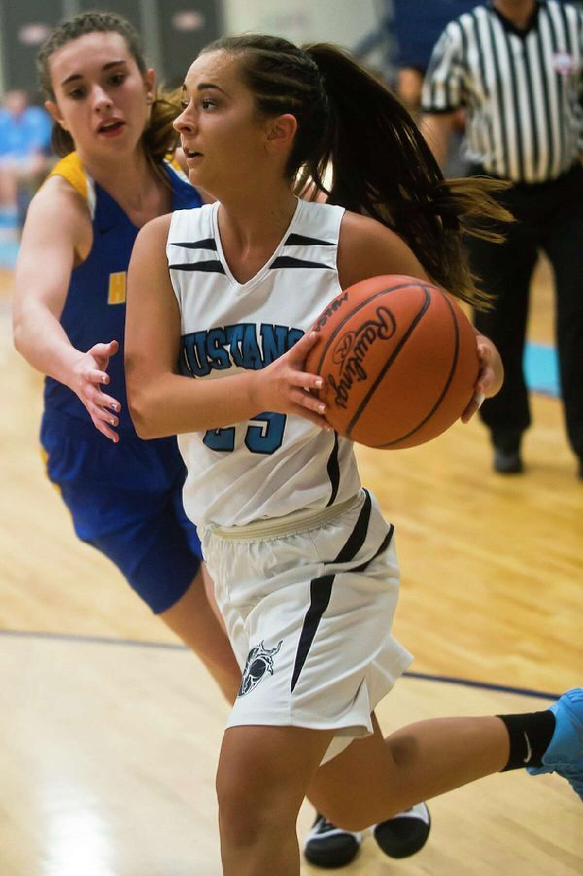 Meridian senior Holly Lavely dribbles toward the basket during the Mustangs' game against Harrison on Thursday at Meridian High School. (Katy Kildee/kkildee@mdn.net)