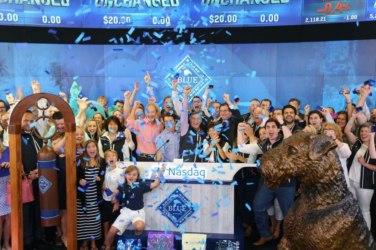 Blue Buffalo “herd members” ring the opening bell for the Nasdaq on Wednesday, July 22, 2015, marking the initial public offering of stock for the premium pet food maker based in Wilton, Conn.