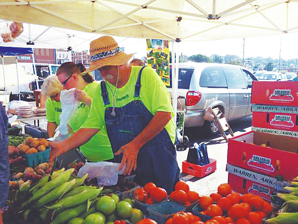 Farmer Bob Sancamper caters to his customers at the Alton Farmers and Artisans Market Saturday.