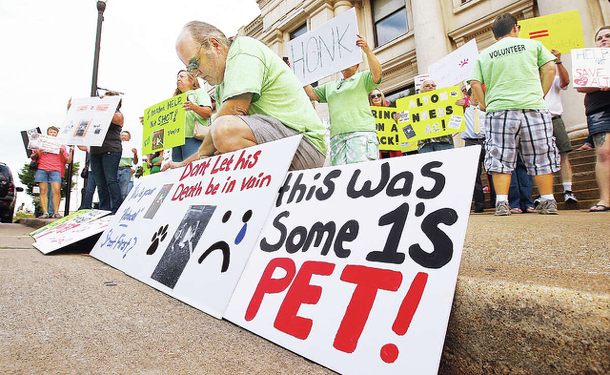 For the second time this month, protestors opposed the possibility of losing the Alton animal control officer position to budget cuts, gathered at Alton City Hall to protest. About 80 people with homemade signs showed up, apparently spurred by the shooting of a dog this week by Alton Police, who are handling most animal complaints right now.
