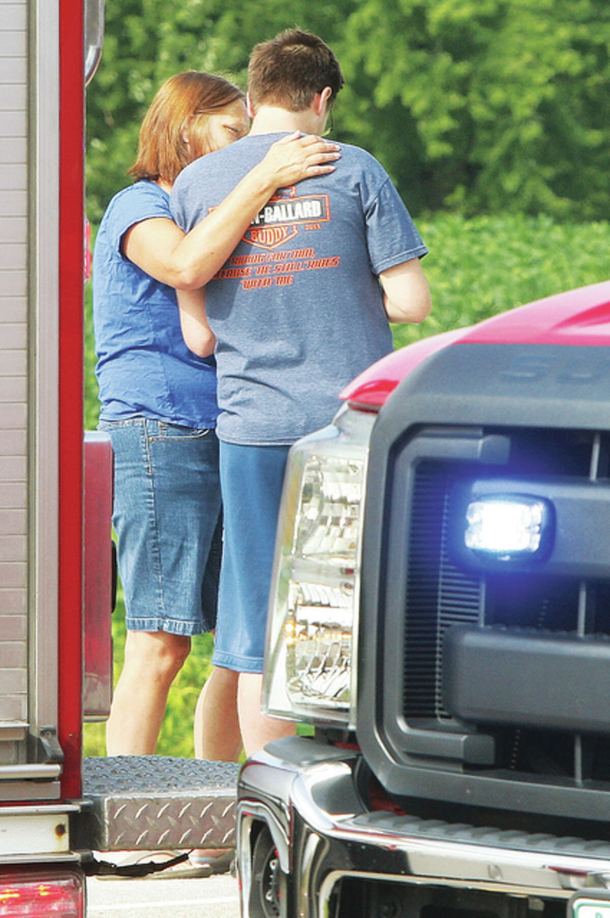 A woman tries to comfort the driver who struck and killed a pedestrian Monday on Illinois Route 140 east of Powder Mill Road in Alton. The driver was composed but distraught after the crash.