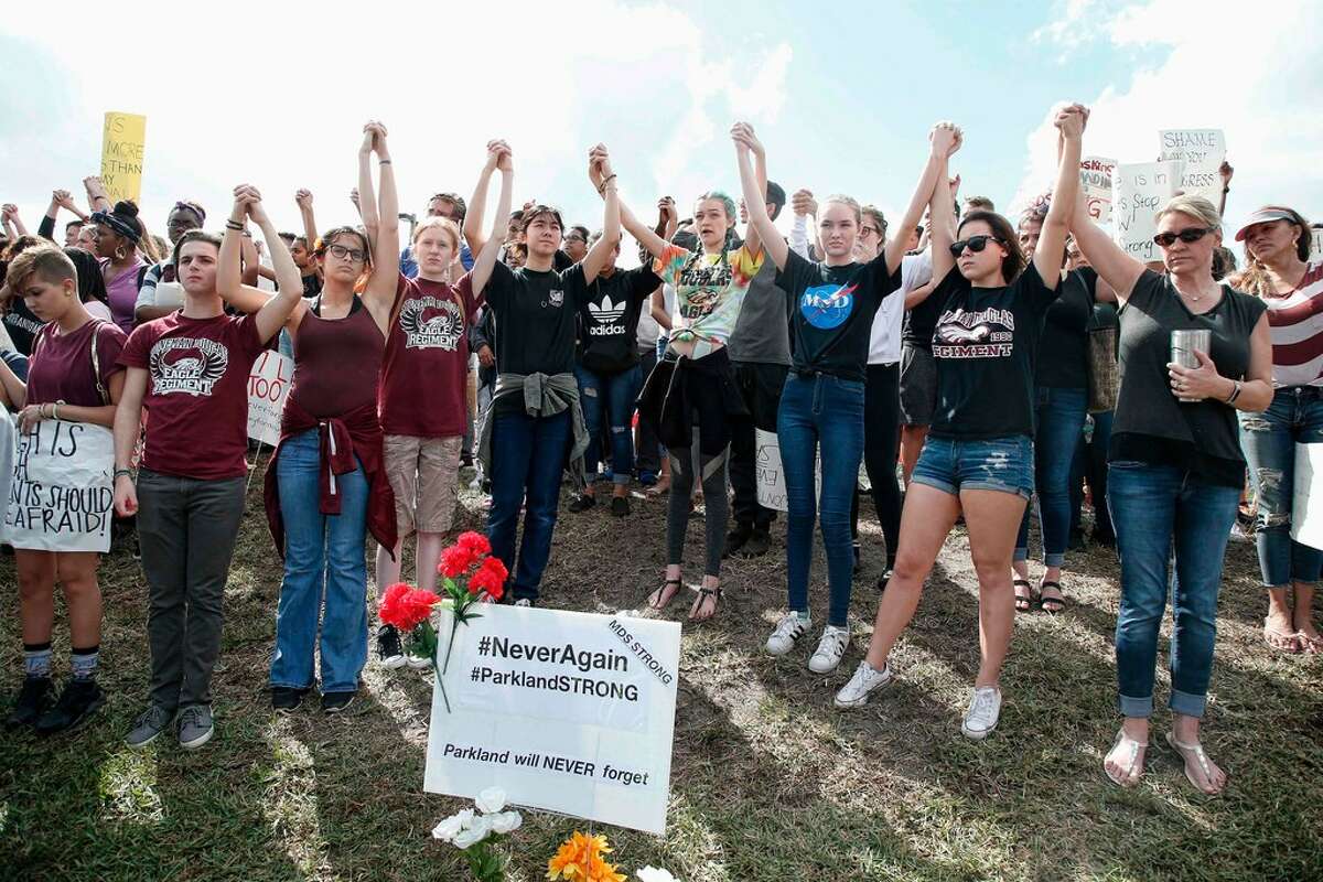10 of 136 AFP_10R7U9 Students of area High Schools rally at Marjory Stoneman Douglas High School after participating in a county wide school walk out in Parkland, Florida on February 21, 2018. A former student, Nikolas Cruz, opened fire at Marjory Stoneman Douglas High School leaving 17 people dead and 15 injured on February 14. / AFP PHOTO / RHONA WISERHONA WISE/AFP/Getty Images