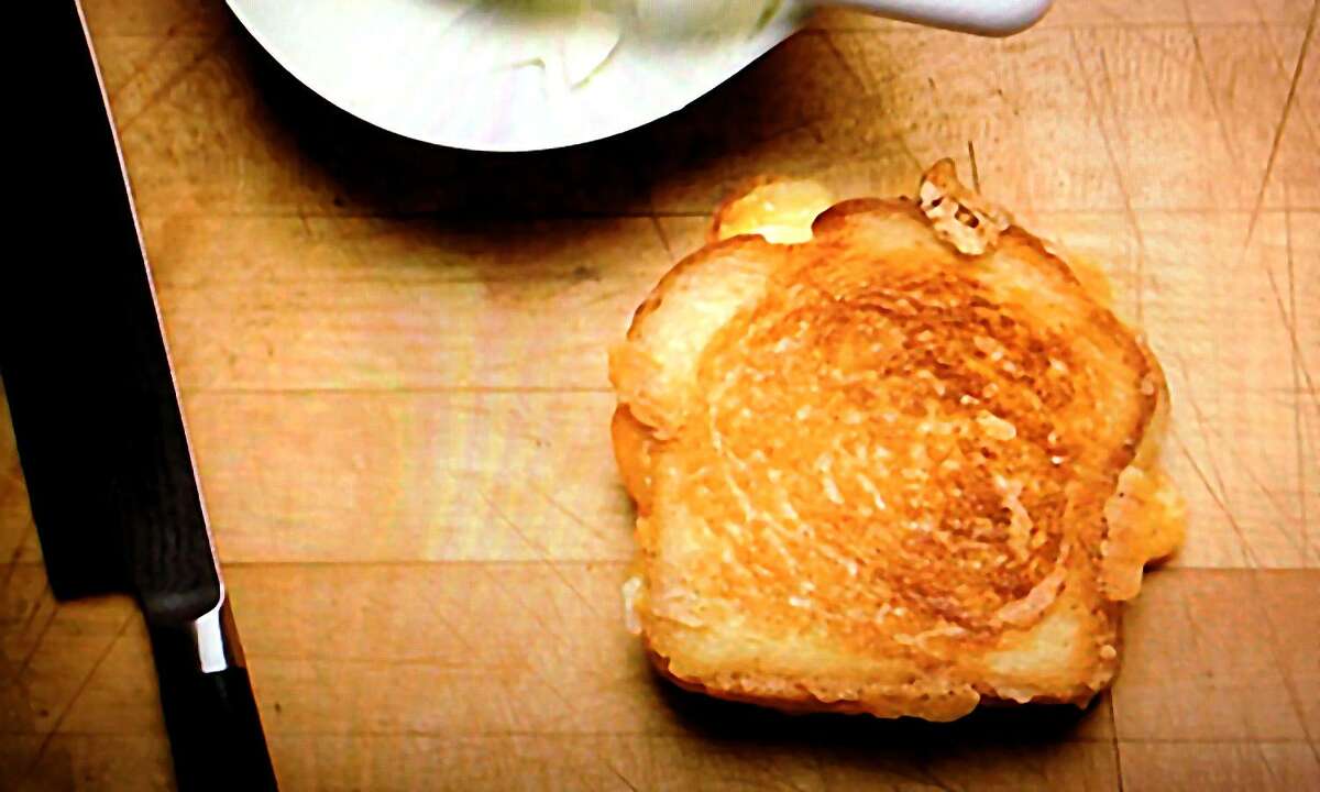 A scene from the film "Chef," featuring a grilled cheese sandwich made by Jon Favreau's chef character for his son with Gruyère, Parmesan and cheddar cheeses.