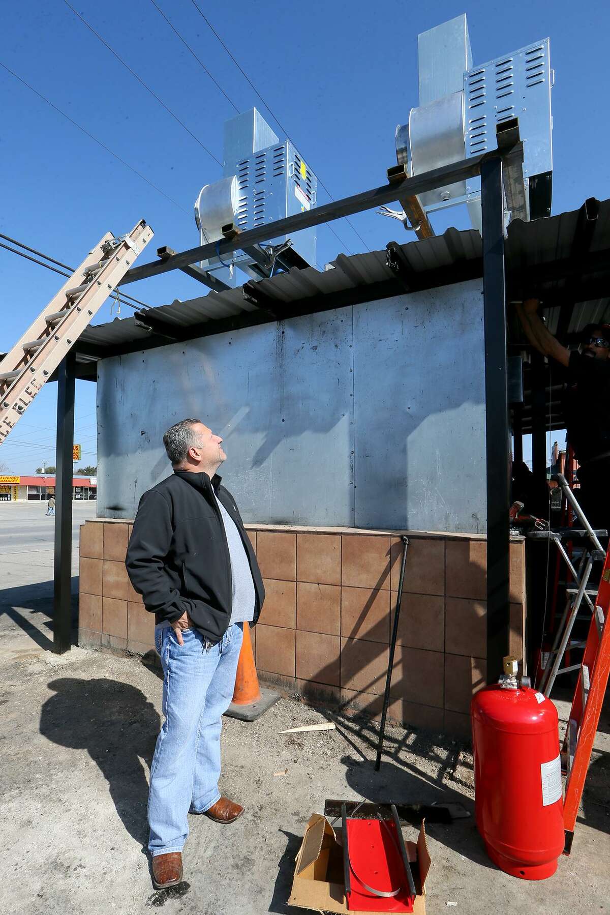 Owner Fank Garcia inspects two high velocity exhaust fans installed on the smokehouse at Pollos Asados Los Norteños in Feb. 2016. Garcia installed new fire suppression and exhaust systems, but it wasn’t enough to keep government officials from shutting down the restaurant.