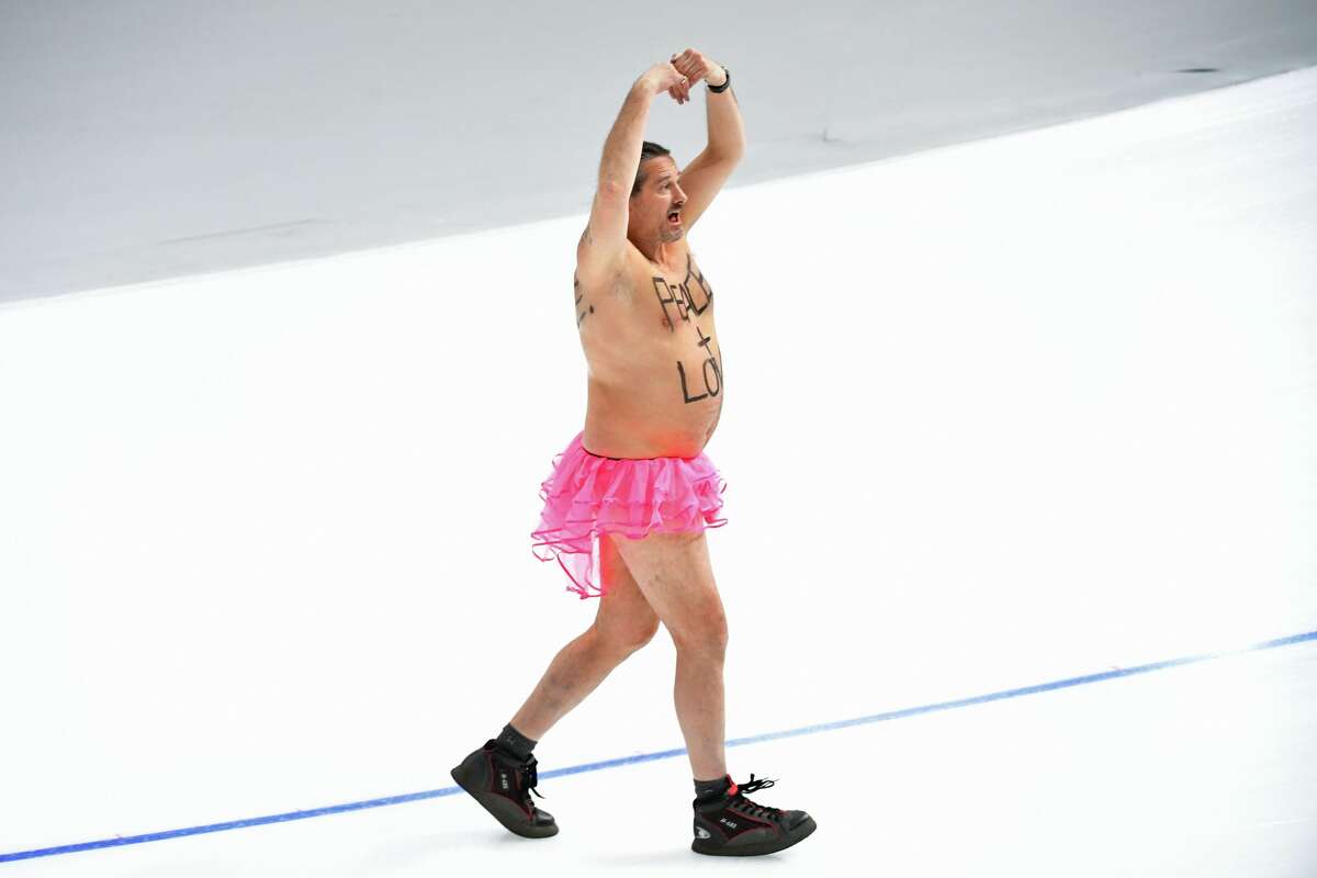 A shirtless man clad in a tutu dances on the rink following the men's 1,000m speed skating event medal ceremony during the Pyeongchang 2018 Winter Olympic Games at the Gangneung Oval in Gangneung on February 23, 2018.