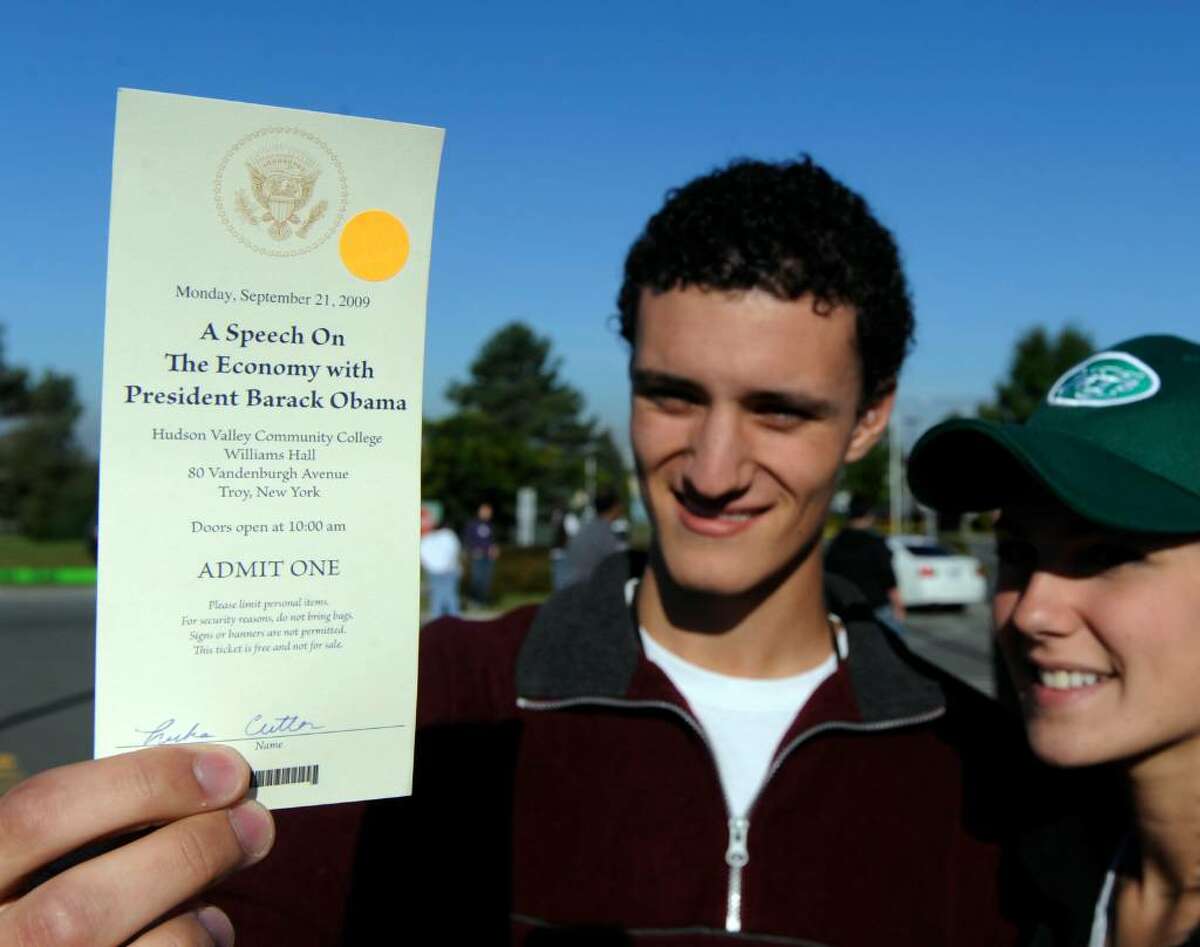 Luke Cutler, 19 of Clifton Park, left, is one of the lucky students to receive a ticket for Monday's visit of President Barak Obama to Hudson Valley Community College in Troy. Erika Frodey, right, 18 of Clifton Park was not on the ticket list and had to leave her friend at the entry point. (Skip Dickstein / Times Union)