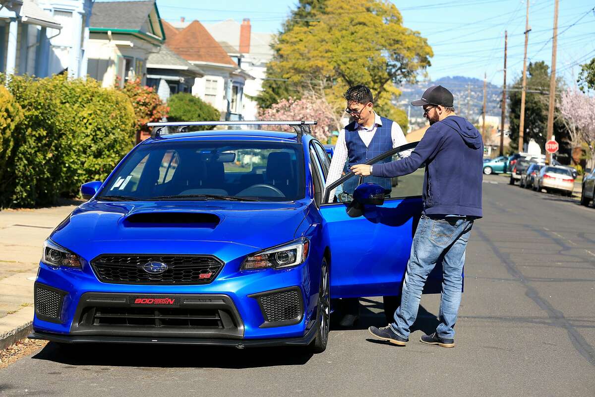 David Chu (l to r) and Tyler Karon, both of Alameda, talk as Karon picks up Chu's car which he rented through Turo in Alameda, Calif., on Friday, February 23, 2018.