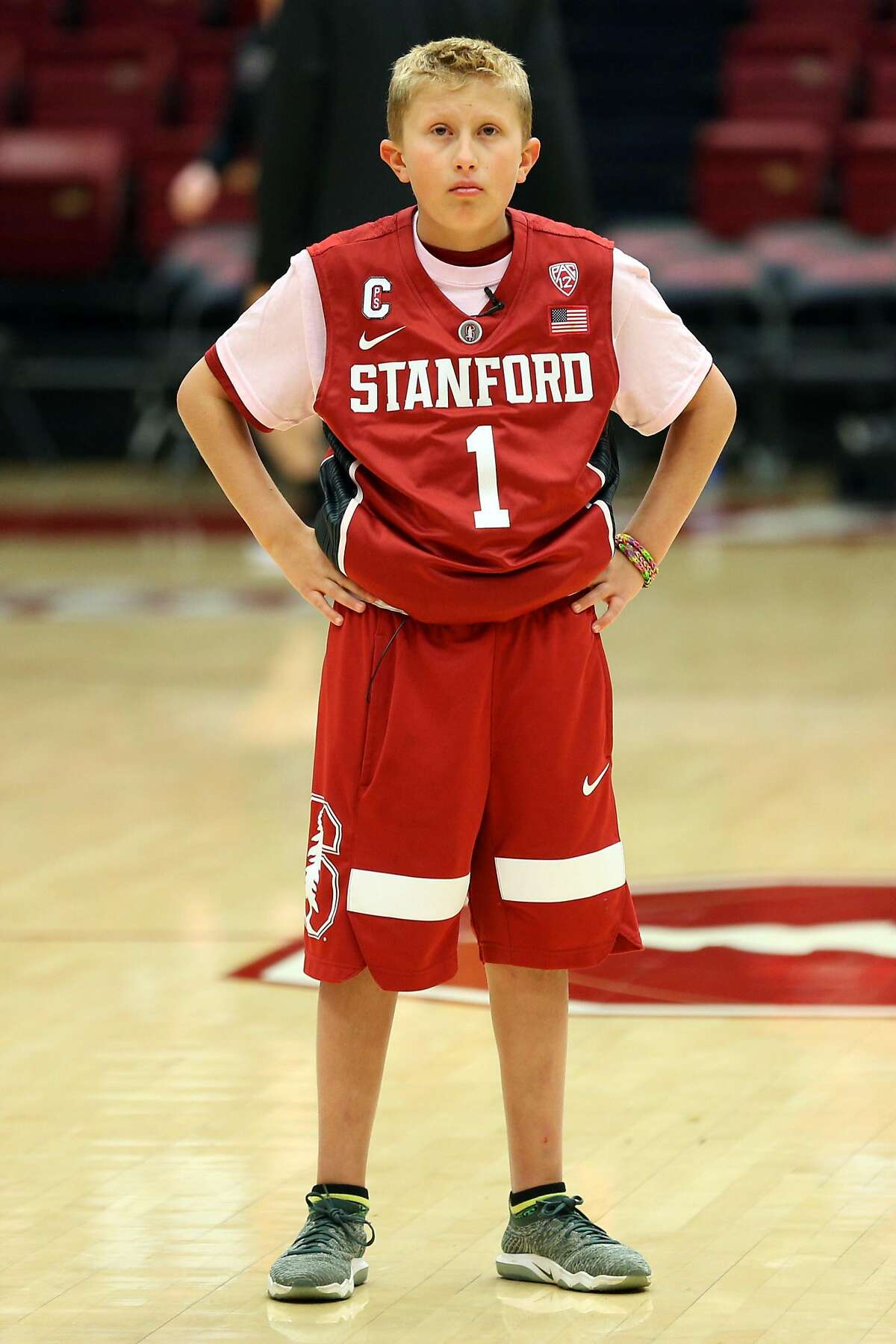 Ty Whisler, 11, helps the Stanford Cardinal warm up before a basketball game between the Stanford Cardinal and Washington Huskies at Maples Pavilion, Thursday, Feb. 22, 2018, in Stanford, Calif. The Cardinal won 94-78.