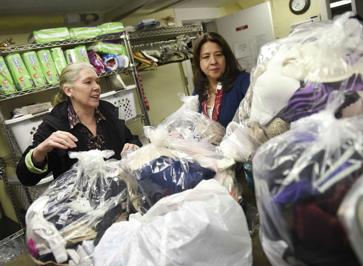 Undies Project co-Presidents Lucy Langley, left, and Laura Delaflor sort this year's Mardi Bra donations at Neighbor to Neighbor in Greenwich, Conn. Thursday, Feb. 22, 2018.