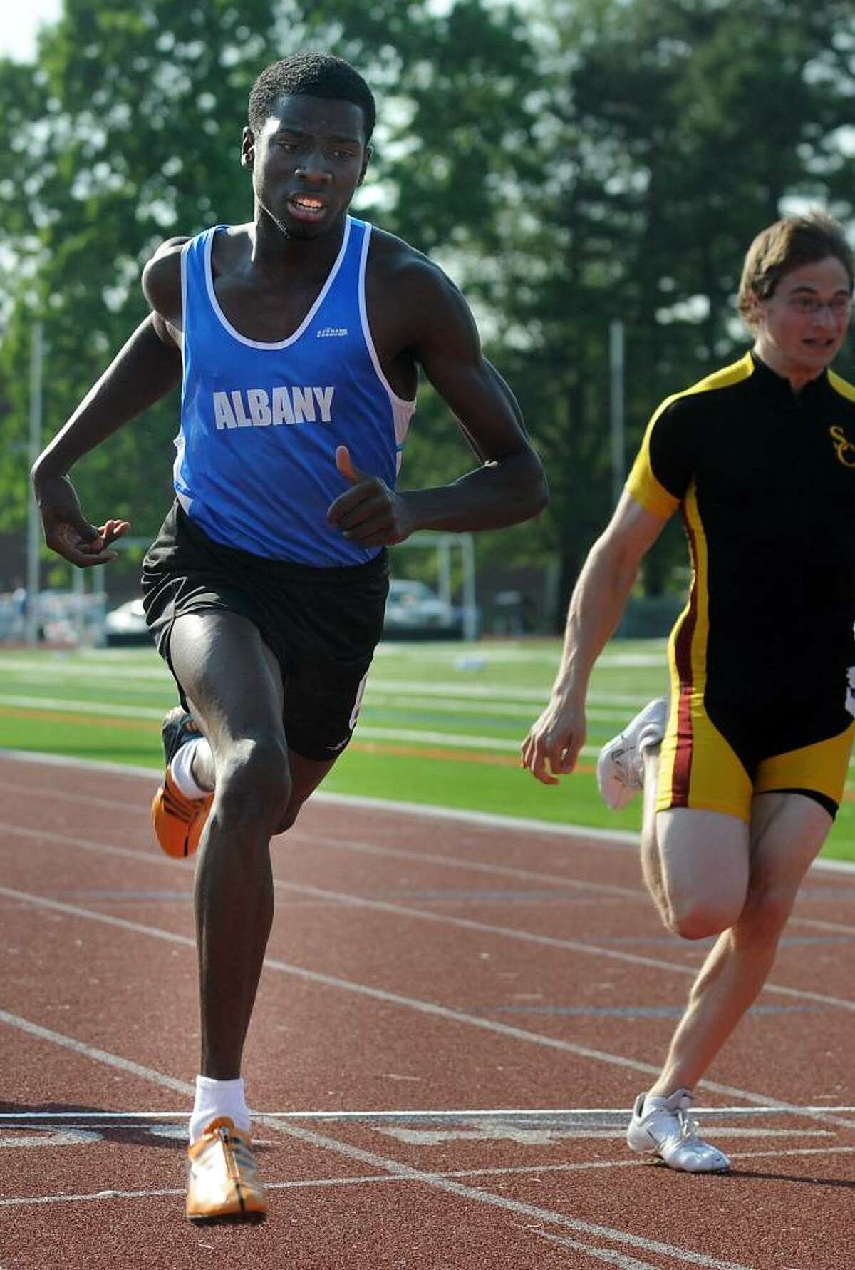Albany's Kareem Morris, left, crosses the line to win the 100-meter run during the Section II track meet on Thursday, May 27, 2010, at Shenendehowa High. (Cindy Schultz / Times Union)