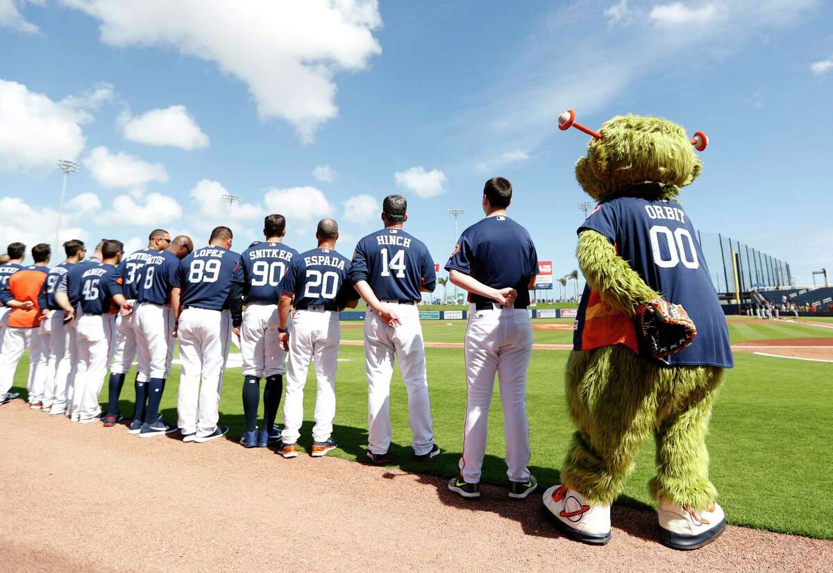 Orbit and the Houston Astros line up for the National Anthem before the start of the Astros Braves spring training game at The Fitteam Ballpark of the Palm Beaches, Saturday, Feb. 24, 2018, in West Palm Beach.
