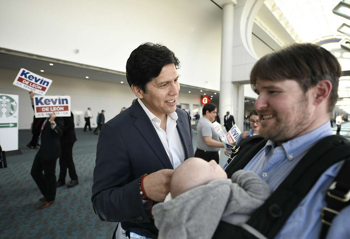 U.S. Senate candidate and California State Senator Kevin de Leon, D- Los Angeles, center, talks with a supporter at the 2018 California Democrats State Convention Saturday, Feb. 24, 2018, in San Diego.