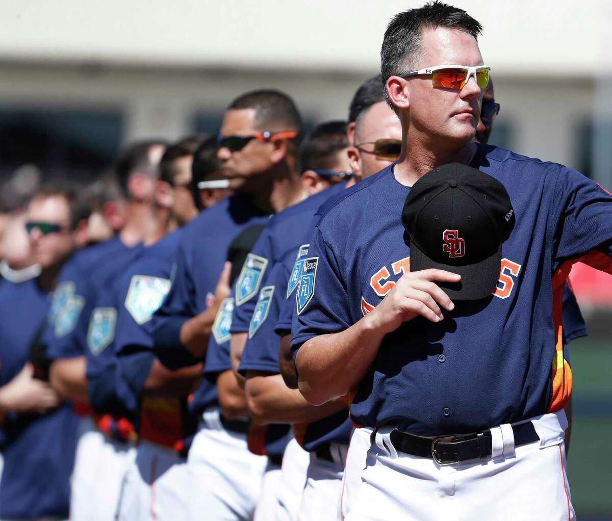 Houston Astros manager A.J. Hinch holds the Stoneman Douglas Eagles baseball hat over his heart during the National Anthem before the start of the Houston Astros spring training game against the Nationals at The Fitteam Ballpark of the Palm Beaches, Friday, Feb. 23, 2018, in West Palm Beach. ( Karen Warren / Houston Chronicle )