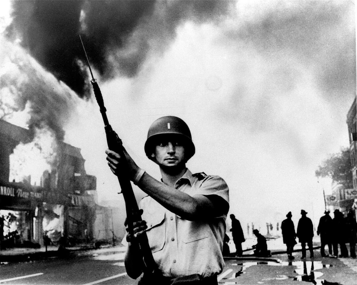A National Guardsman patrols a Detroit intersection during the July 1967 riots. That summer, 150 cases of civil unrest erupted across the country.