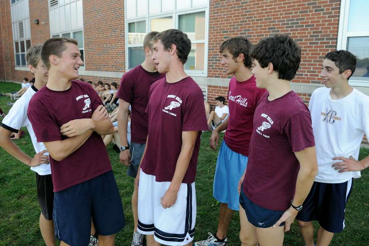 Scott Maughan, left, Chris Fernandez, center, and Sean Pezzulo, right in foreground, members of the Burnt Hills-Ballston Lake cross country team, chat before their workout. (Skip Dickstein / Times Union)