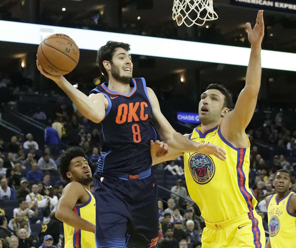 Oklahoma City Thunder guard Alex Abrines (8) is pressured by Golden State Warriors center Zaza Pachulia (27) and Nick Young on Saturday, Feb. 24, 2018 in Oakland, CA.