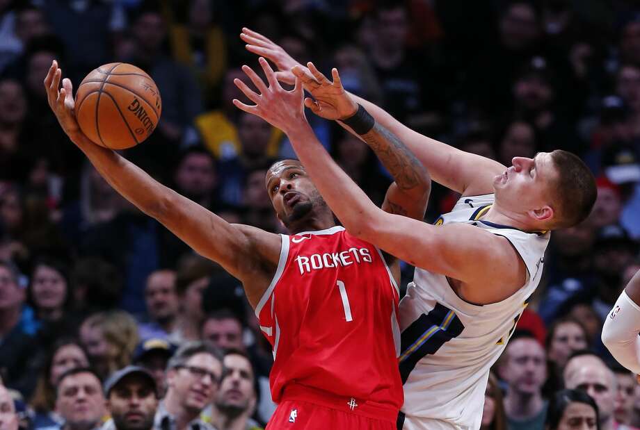 Houston Rockets forward Trevor Ariza (1) and Denver Nuggets center Nikola Jokic (15) reach for a rebound during the second quarter of an NBA basketball game, Sunday, Feb. 25, 2018, in Denver. (AP Photo/Jack Dempsey) Photo: Jack Dempsey/Associated Press