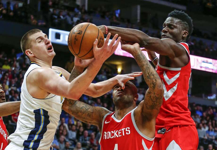 Denver Nuggets center Nikola Jokic (15), Houston Rockets forward PJ Tucker (4) and Clint Capela (15) reach for a loose ball during the third quarter of an NBA basketball game, Sunday, Feb. 25, 2018, in Denver. (AP Photo/Jack Dempsey) Photo: Jack Dempsey/Associated Press