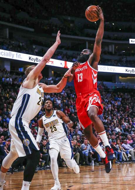 Houston Rockets guard James Harden (13) goes up to shoot against Denver Nuggets center Mason Plumlee (24) and Malik Beasley (25) during the second quarter of an NBA basketball game, Sunday, Feb. 25, 2018, in Denver. (AP Photo/Jack Dempsey) Photo: Jack Dempsey/Associated Press