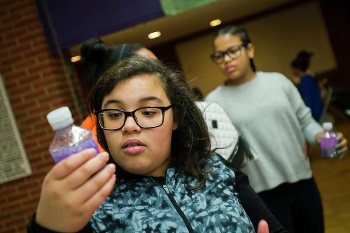 Her own personal galaxy Jasmine Watkins, 11, checks out her galaxy-themed glitter shaker during The ROCK after school program on Thursday afternoon at the Greater Midland Community Center. (Katy Kildee/kkildee@mdn.net)