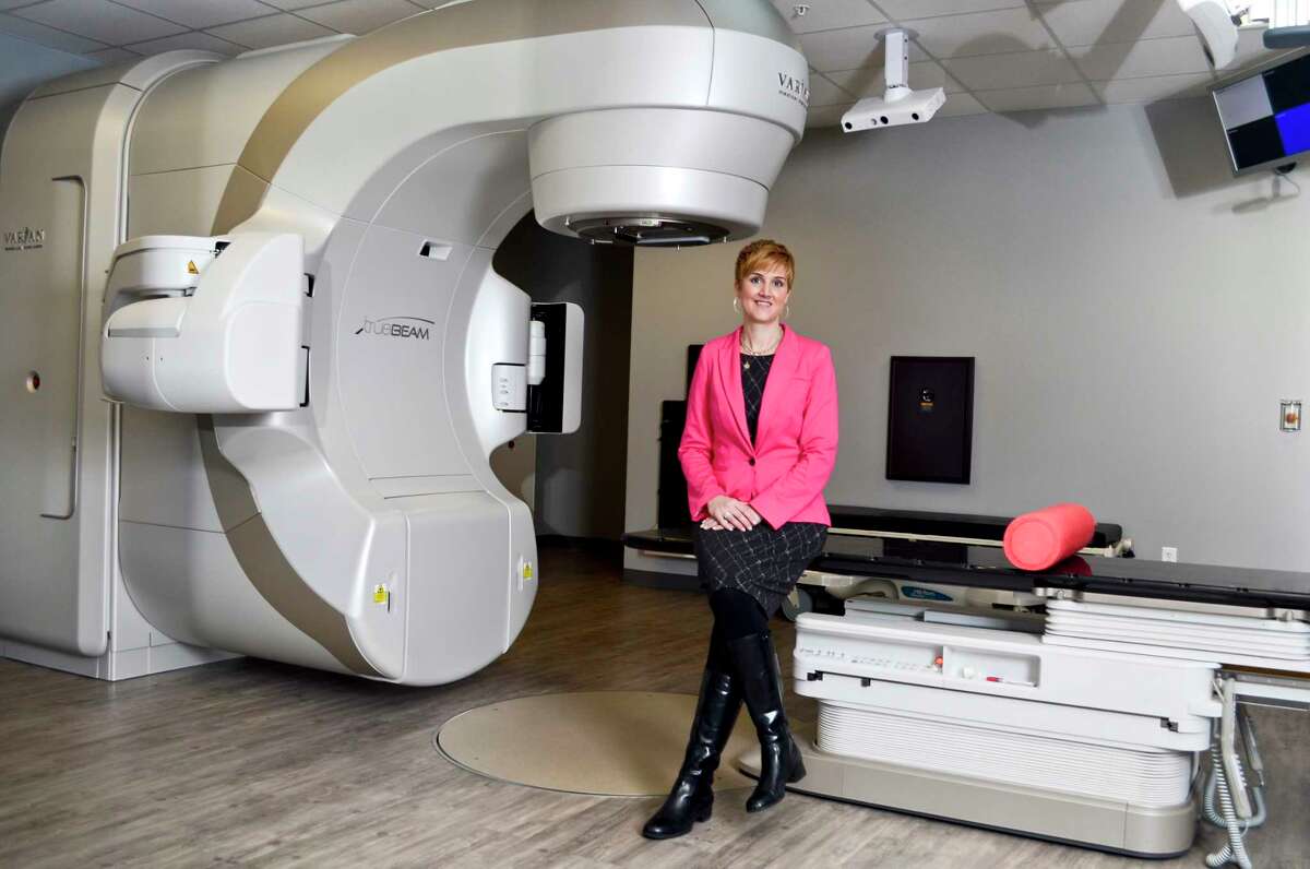 Megan Farrar, R.T., Director of Radiation and Imaging Services at New York Oncology Hematology, poses for a picture in front of a linear accelerator at NYOH in Clifton Park, NY, on Tuesday, January 30, 2018. (Photo by Colleen Ingerto / Times Union)