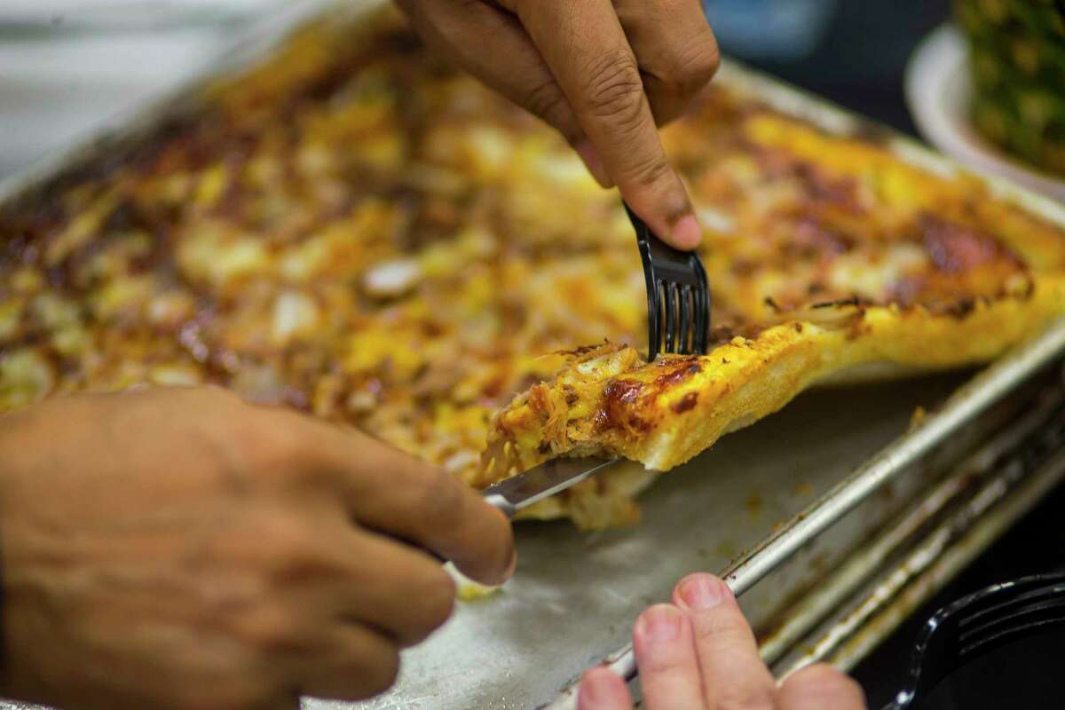 Pizza is sliced for the judges during the judging of the Gold Buckle Foodie Awards in the Main Club of NRG Center, Monday, Feb. 26, 2018, in Houston. Judges tasted food that is available to the general public throughout the carnival and rodeo in several categories from "best dessert" to "most creative."