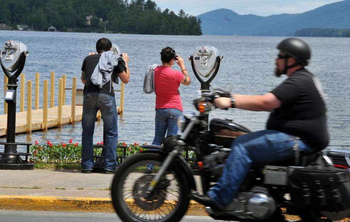 Joe Ramirez, left, and his wife, Alex Leshkevich, of Kingston don't mind the roar of motorcycles as they look out over Lake George Tuesday June 8, 2010. This is the second time the pair is celebrating their anniversary at Americade.