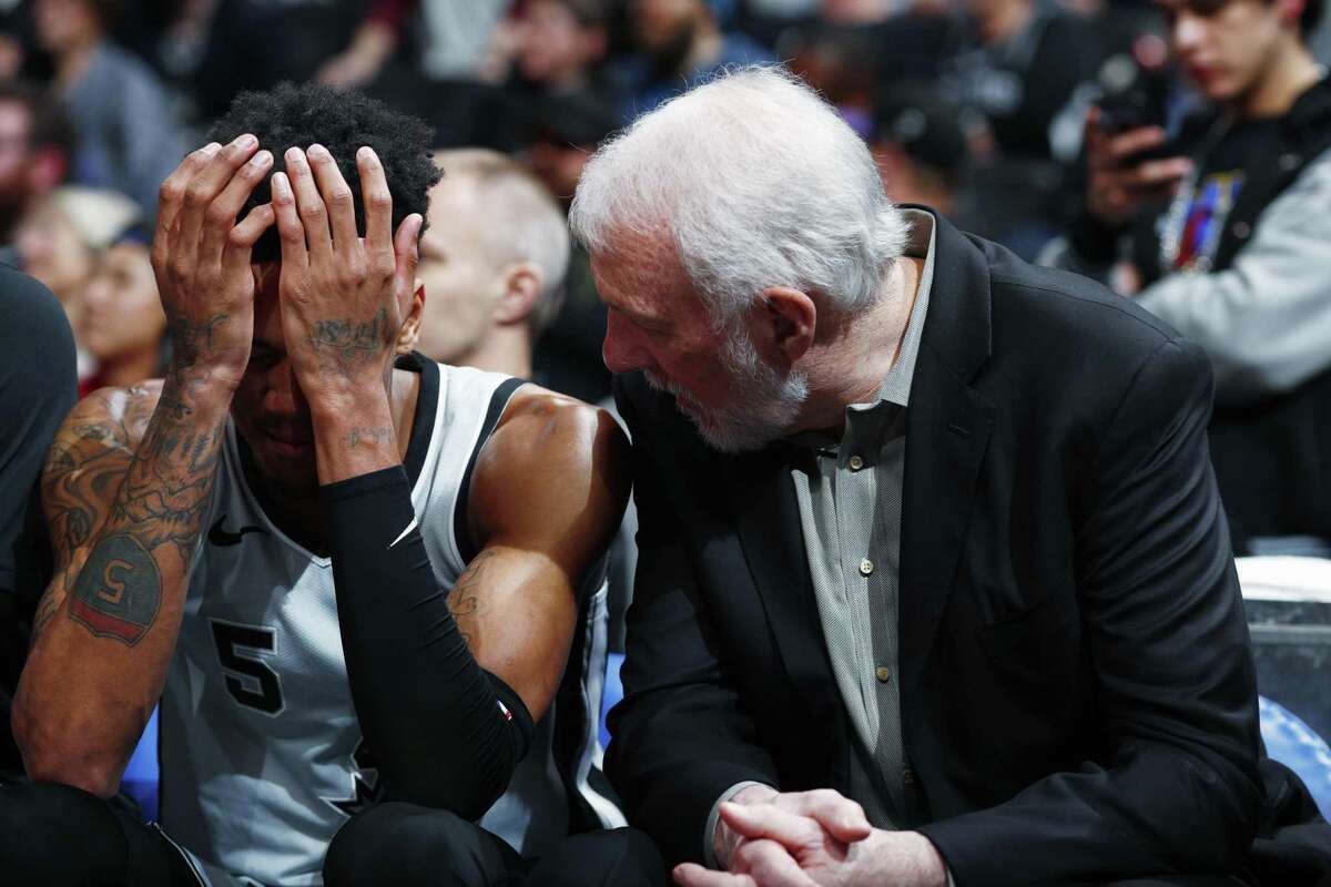 San Antonio Spurs guard Dejounte Murray and San Antonio Spurs head coach Gregg Popovich confer in the second half of an NBA basketball game Tuesday, Feb. 13, 2018, in Denver. Vegas win projections for the 2018-19 season would mean the Spurs would not make the postseason in the West.