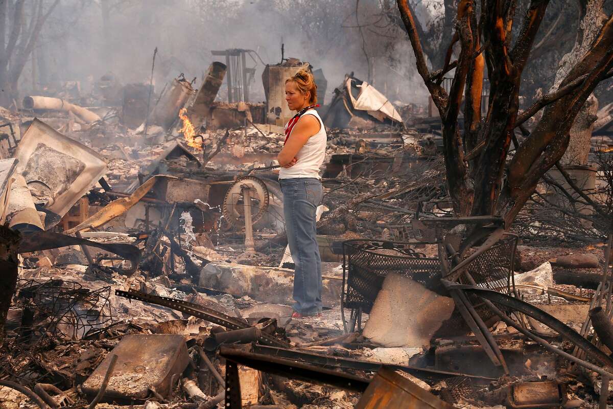 Terrie Burns stands in the middle of her destroyed at the scene of the Tubbs Fire in Santa Rosa, Ca., on Monday October 9, 2017.
