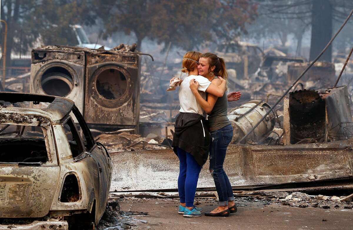 Erica Rinkor, (left) comforts Brandi Burns in front of her destroyed home at the scene of the Tubbs Fire in Santa Rosa, Ca., on Monday October 9, 2017. Massive wildfires ripped through Napa and Sonoma counties early Monday, destroying hundreds of homes and businesses on Monday October 9, 2017