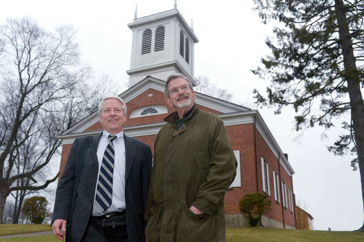 Charles Harris, Norwalk Preservation Trust board member and chairman of the Trust's new scholarship program, and Trust President Todd Bryant at the Mill Hill Historic Complex in Norwalk on Friday. The Trust will begin offering its first scholarship to high school students in Norwalk.