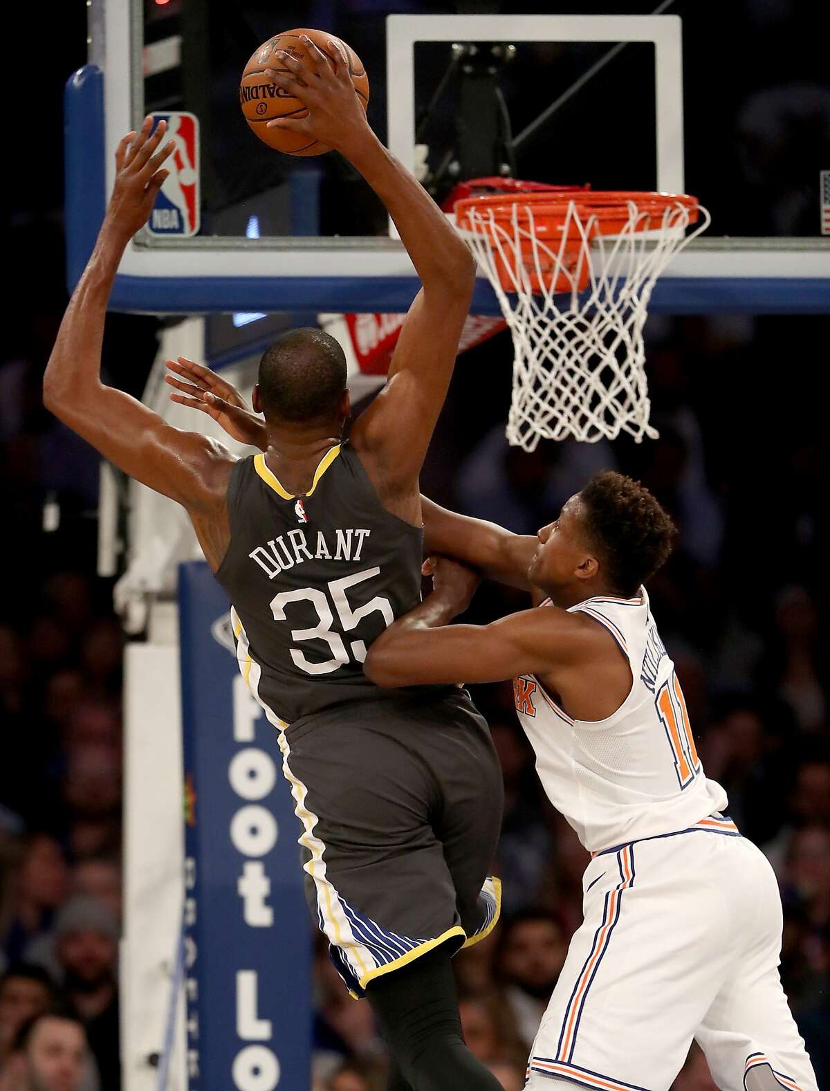 NEW YORK, NY - FEBRUARY 26: Kevin Durant #35 of the Golden State Warriors is fouled by Frank Ntilikina #11 of the New York Knicks at Madison Square Garden on February 26, 2018 in New York City. NOTE TO USER: User expressly acknowledges and agrees that, by downloading and or using this Photograph, user is consenting to the terms and conditions of the Getty Images License Agreement (Photo by Elsa/Getty Images)