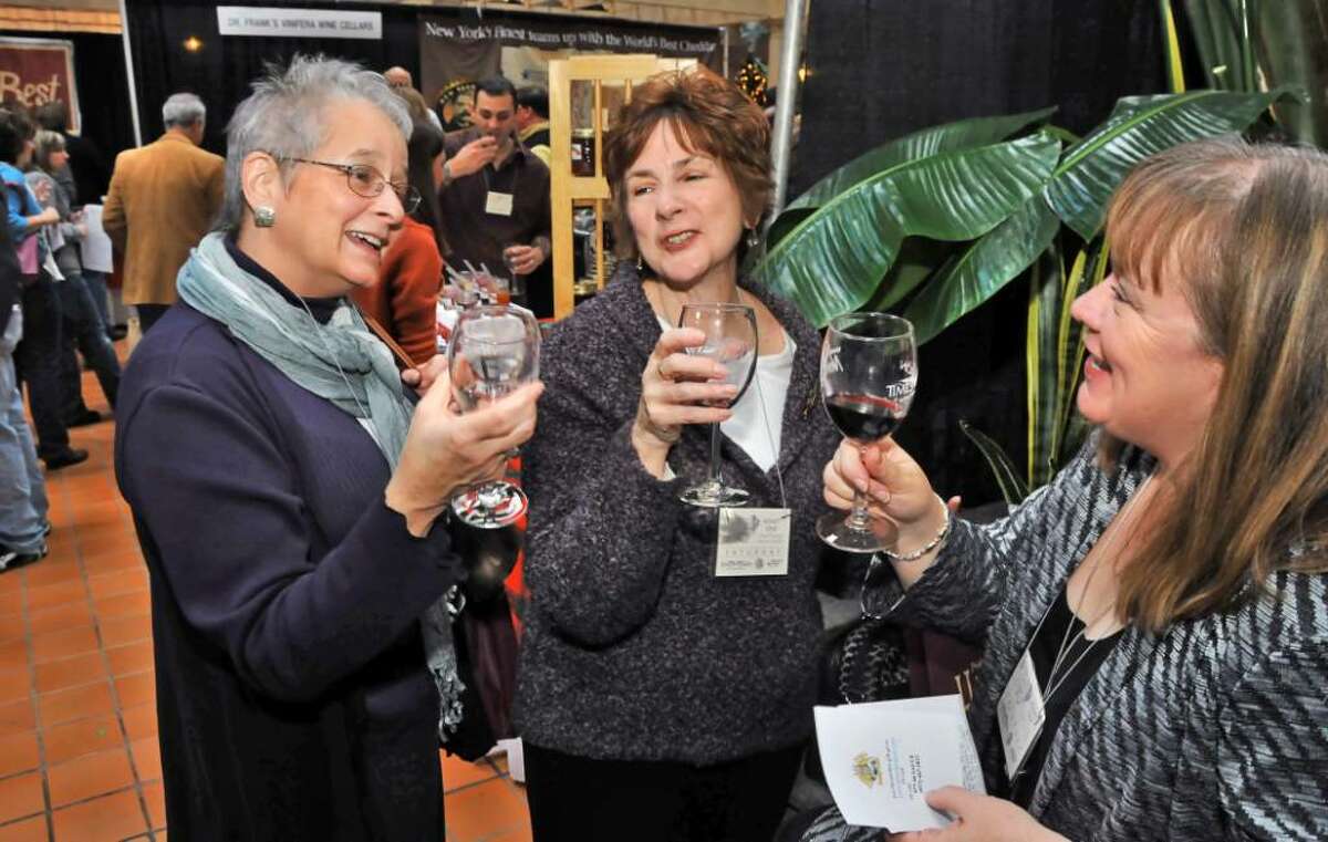 Friends Jill Messner, left, of Albany, Jean Clother of Clifton Park and Linda Whelton, right, of Latham attend the Pride of New York Harvest Fest, a celebration of wine and food from throughout the state at the Desmond Hotel and Conference Center in Colonie Saturday, Dec. 12.The event continues Sunday, Dec. 13. (John Carl D'Annibale / Times Union)