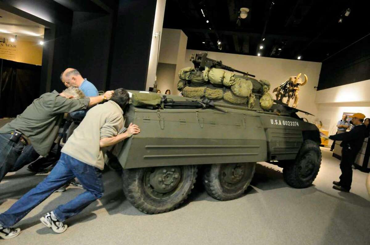 A 16,000-pound M8 Greyhound Light Armored Car is moved into the New York State Museum as part of an exhibition starting May 28.( Michael P. Farrell / Times Union)