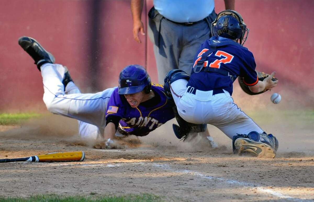 Saratoga Central Catholic's Dylan Anderson scores the winning run in the bottom of the seventh inning as Potsdam catcher Lee Buchanan can't hold onto the throw, during their 7-6 win in a state Class B tournament game at Bleecker Stadium in Albany. (Philip Kamrass / Times Union)