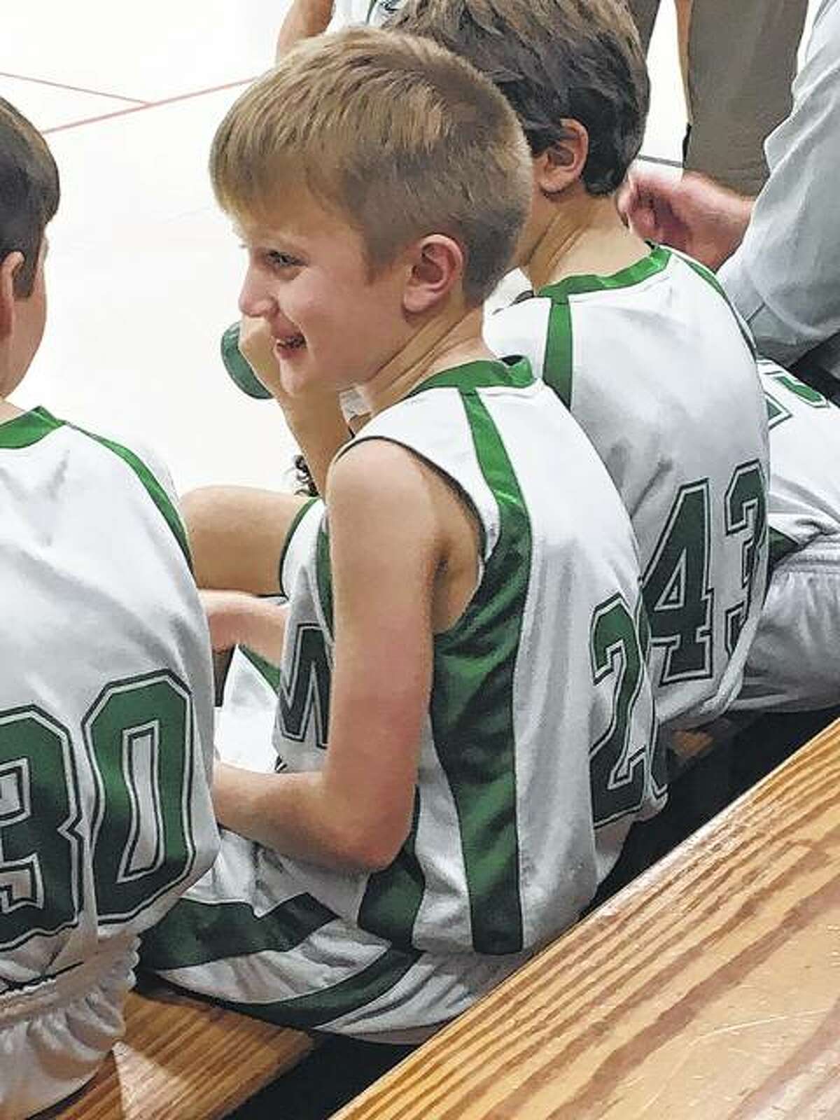 Salem Lutheran School players wait for the start of a basketball game.