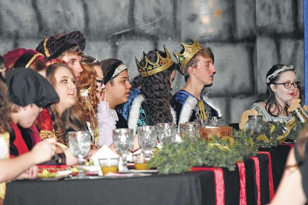 Members of the JHS Madrigals prepare to eat Saturday during the JHS Madrigal Dinner.