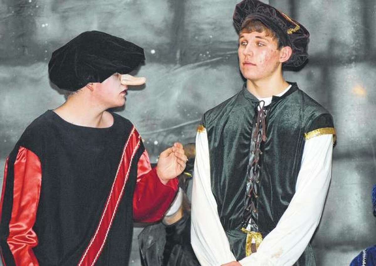 Collin Oberg (right) playing Cyrano and Nick Hester, playing Christian from the play “Cyrano” act out a scene Saturday during the Jacksonville High School Madrigal Dinner.