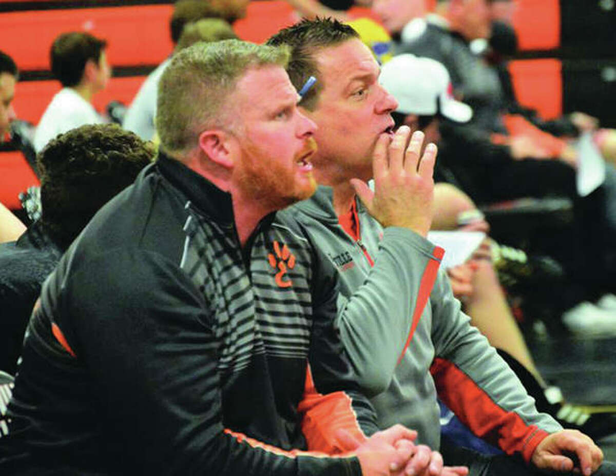 Edwardsville coach Jon Wagner (right) and assistant Doug Heinz watch the heavyweight match during a SWC dual with Alton earlier this season in Edwardsville. The Tigers won their seventh straight Class 3A regional championship Saturday at Quincy.