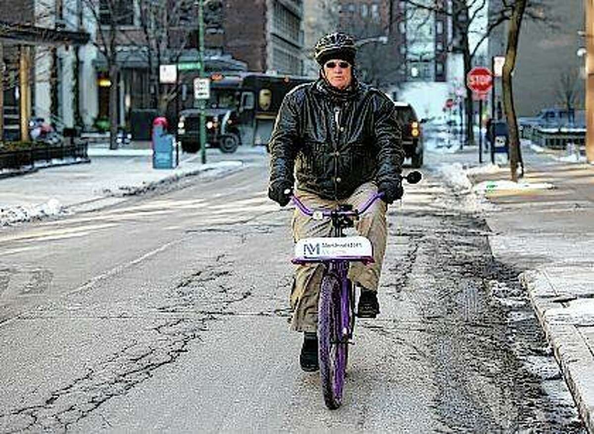 Nurse practitioner Dwayne Dobschuetz rides his bicycle to visit an elderly patient at home in Chicago. Dobschuetz makes several home visits a day for Northwestern Medicine to check vitals and answer questions with the goal of helping seniors stay healthier and out of the hospital. Teresa Crawford | AP