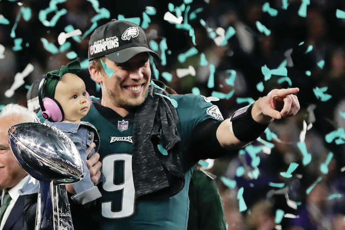 Eagles QB Nick Foles holds his daughter, Lily James, after winning Super Bowl 52 and MVP honors with a 41-33 victory over the New England Patriots on Sunday in Minneapolis.