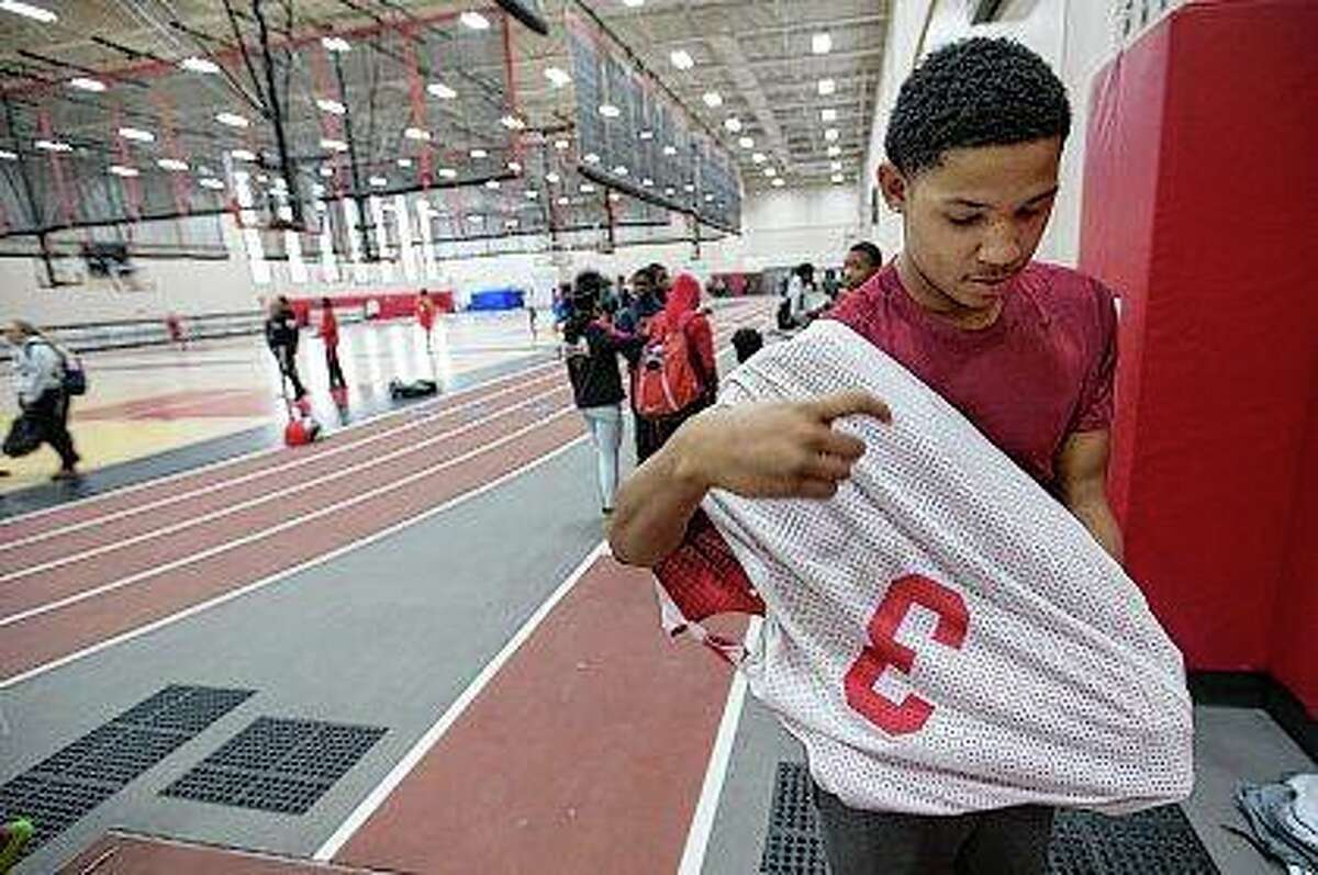 Chris Barnell puts on his practice jersey with the number 3 before practice at Rockford East High School. Barnell, a friend and teammate of Greg Hill, who was shot and killed July 31, 2016, asked head coach Roy Sackmaster, if he could wear Hill's number this year to carry on his memory through basketball. Burnell was a pallbearer at Hill's funeral. Arturo Fernandez | Rockford Register Star (AP)