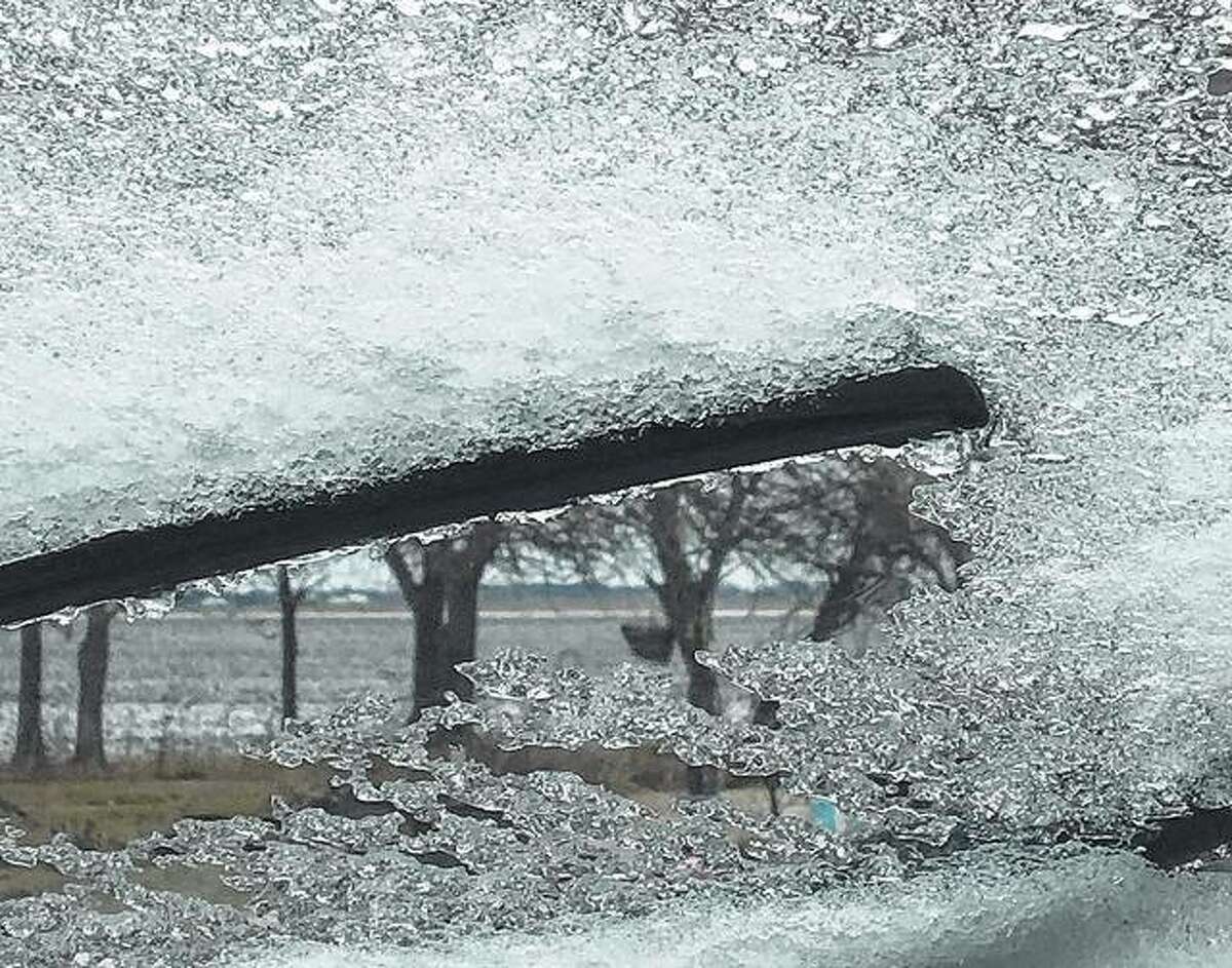 A windshield wiper scrapes away the reminders of freezing rain that fell in the region overnight.