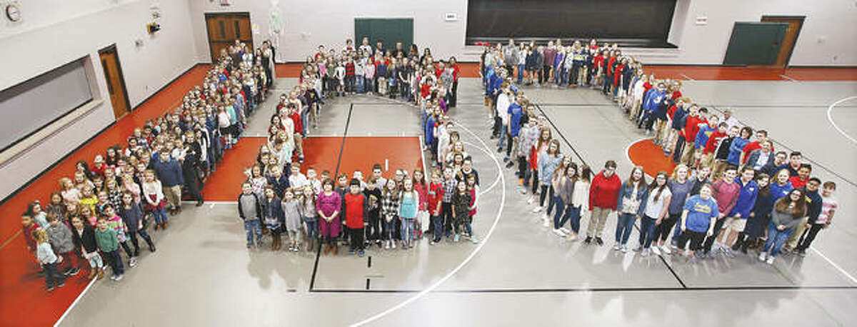 Students at Godfrey’s Evangelical School formed the number 100 on the gym floor at the school Thursday in honor of the 100th birthday of Robert Wadlow, Alton’s “Gentle Giant” and the tallest man in the world. Robert Wadlow, who grew to 8 feet, 11.1 inches tall, died at the age of 22 in 1940. A variety of activities were held around town Thursday for his birthday.
