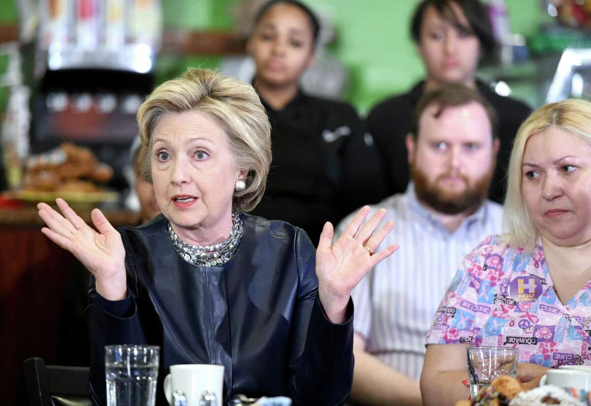 (Arnold Gold-New Haven Register) Democratic presidential candidate Hillary Clinton (left) speaks at a campaign stop at Orangeside on Temple in New Haven, Connecticut, on April 23, 2016. At right is Maribel Rodriguez a Certified Nursing Assistant from Waterbury.